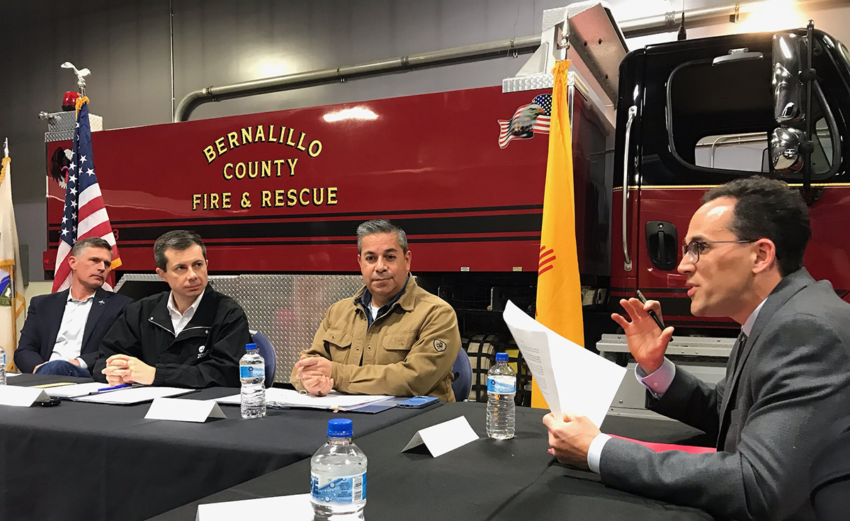 photo: Nick Ferenchak (right) presents April 4 to Sen. Martin Heinrich (left), Secretary of Transportation Pete Buttigieg and Sen. Ben Ray Lujan.